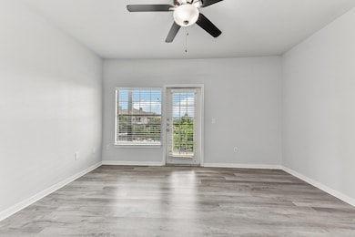 Empty room featuring a ceiling fan, wood finished