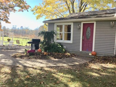 view of back door, brick walkway and patio.