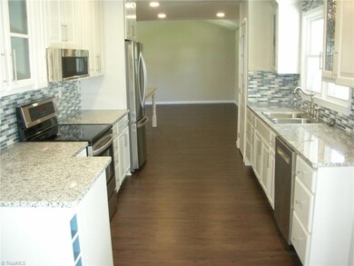 Kitchen: Features include vinyl plank flooring for easy cleaning, 2 windows for natural lighting, recessed lighting, fresh paint, bright cabinets and SST appliances - Microwave, Dishwasher, Slide in Stove and Refrigerator, Granite counter tops, decorative backsplash and new fixtures.