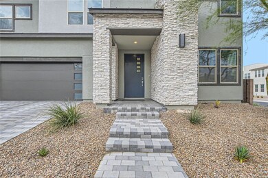 Property entrance with stone siding, stucco siding