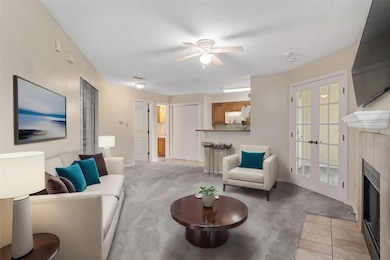 Living area featuring light carpet, visible vents,