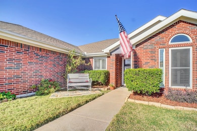 Property entrance with brick siding and a yard
