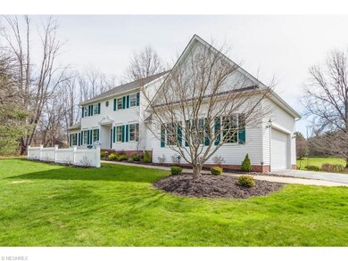 This 4 bedroom colonial is nestled on a wooded 4.7
