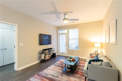 Living room with dark wood-type flooring and ceili