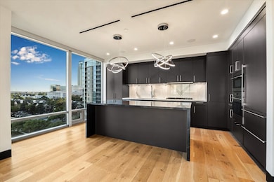 This open-concept luxury kitchen features sleek cu