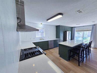 Kitchen with sink, light hardwood / wood-style flo