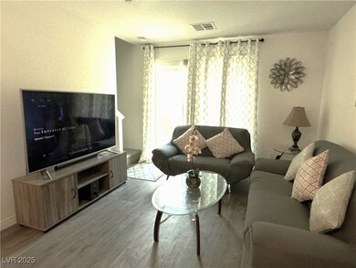 Living room with visible vents, a textured ceiling