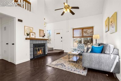 Living area with high vaulted ceiling, a fireplace