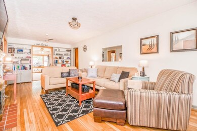 Living room with wood flooring and a fireplace.