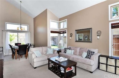 Living and dining rooms with vaulted ceiling and 2