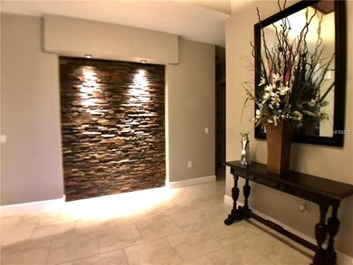 Large foyer - decorative stone wall and cedar enha