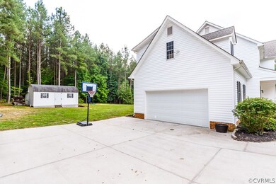 Garage entrance with concrete portion of driveway.