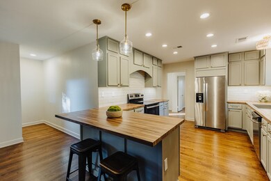 Kitchen with light hardwood / wood-style floors, b