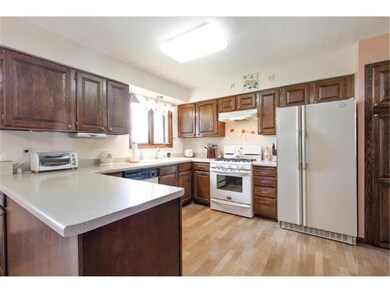 Large open neutral kitchen with lamininate floorin