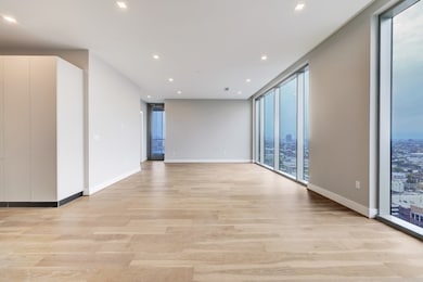Spacious, modern open-concept living area with har
