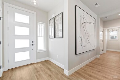 Foyer entrance with baseboards and light wood-style flooring
