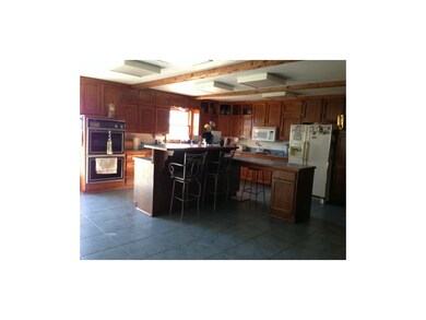 Large kitchen with custom cabinets, double oven an