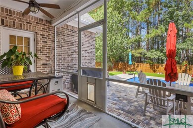 Screened in porch overlooking pool