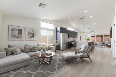 Living room featuring visible vents, light wood-st