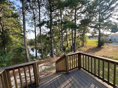 Wooden deck with a lawn and a water view
