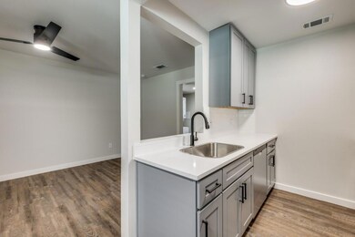 Kitchen featuring backsplash, ceiling fan, sink, h