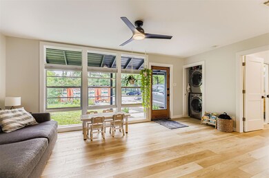 Living area featuring stacked washer / dryer, a c