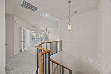 Hallway featuring carpet floors, an upstairs land