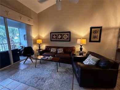 Living room with tile patterned floors and high va