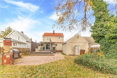Rear view of property with a deck, a chimney, and a patio area