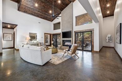 Living room featuring a high ceiling, wood ceiling