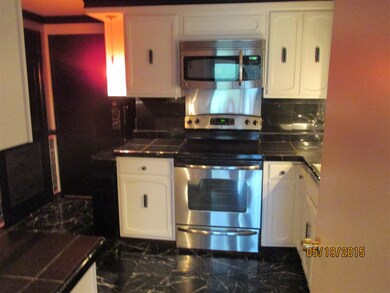 Marble floors and tile countertops and backsplash.