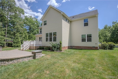 Rear view of house with a patio area and a yard