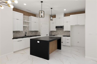 Kitchen featuring light marble finish flooring, stainless steel microwave, decorative backsplash, recessed lighting, and open shelves