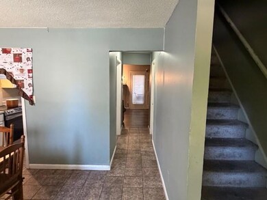 Hall featuring stairs and a textured ceiling