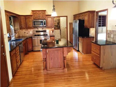 Extensively updated gourmet kitchen features solid