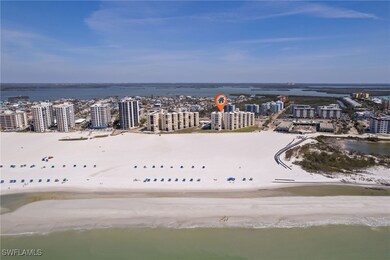 Aerial view featuring a beach view, a water view,