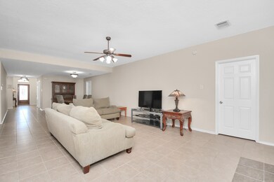 Open concept living gives this home a comfortable easy flow great for entertaining! View from the living room back to the dining room and foyer.