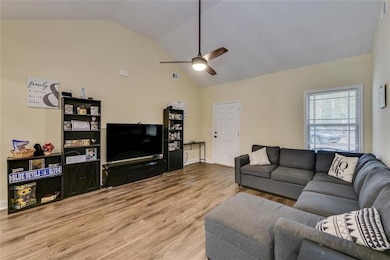 Living area featuring wood finished floors, visibl