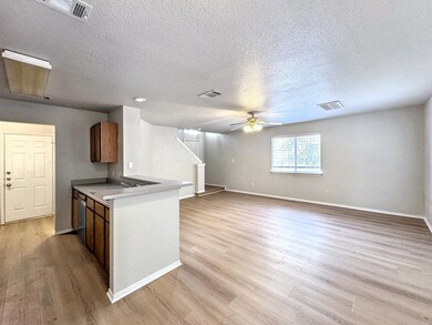 Kitchen featuring ceiling fan, a textured ceiling