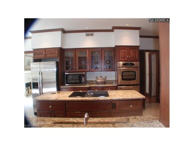 Cherry cabinets with granite counter and new stainles steel stove, microwave and refrigerator.