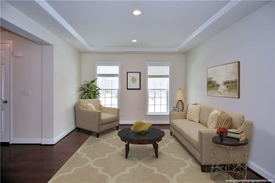 Gorgeous hardwood floors, large windows and tray ceiling grace the living room. Note: room is virtually stage.