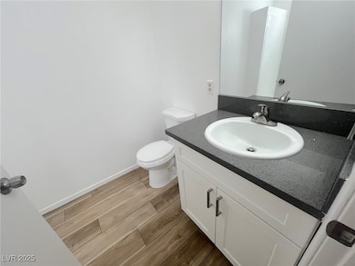 Bathroom featuring vanity, wood finished floors, a