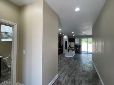 Hall featuring dark wood-style flooring and recess