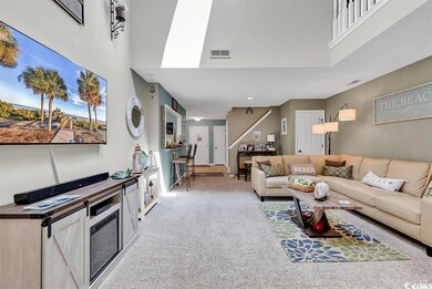 Living area with carpet floors, a towering ceiling
