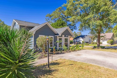 View of front of home with a front yard and a gara