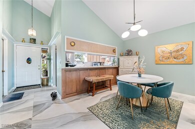 Dining space featuring high vaulted ceiling