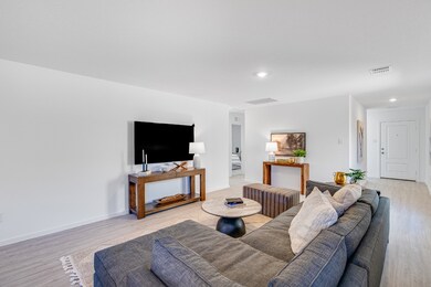 Living area featuring light wood-style floors and recessed lighting