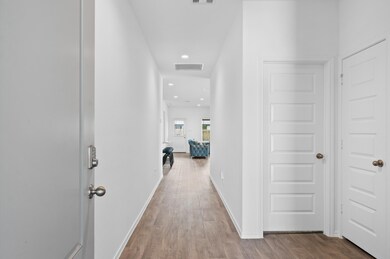 A modern, bright hallway with white walls, and rec