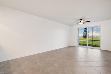 Spare room featuring ceiling fan and light tile fl