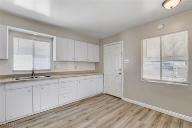 Kitchen featuring wood-style flooring, tasteful ba